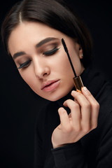 Obraz premium Beauty Makeup. Woman With Long Black Eyelashes And Mascara Brush