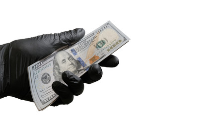 A bundle of US dollars in a male hand in a black glove. Object for the design of the concept of...