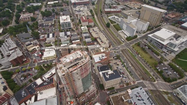 North Carolina Durham Aerial v4 Panning birdseye overtop construction with city views 10/17