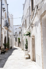 A street in an Italian village with white houses