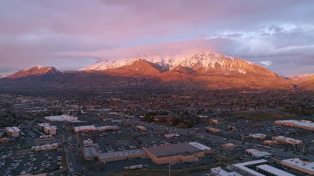 Aerial view of State Street in Orem Utah during sunset viewing Mt. Timpanogos snow capped and lit up by the sun on the winter solstice.
