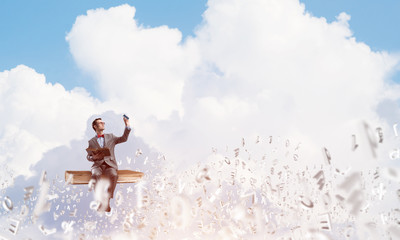 Young businessman or student studying the science and symbols fly around