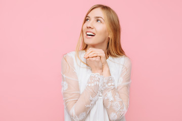 Happy enthusiastic girl in a white dress, dreams of something, making plans, and looking at an...