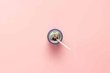 Open can with a drink or empty with straw on a pink background. minimalism. Concept of day and night, caffeine, energy drink, holiday. Flat lay, top view