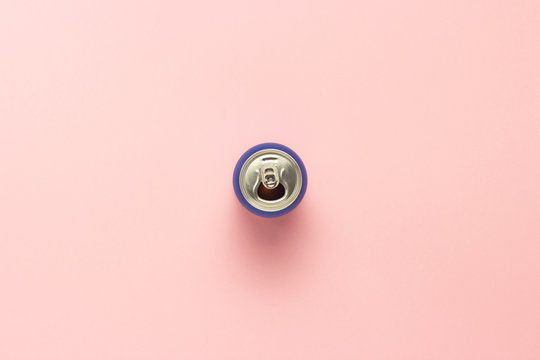 Open can with a drink or empty on a pink background. minimalism. Concept of day and night, caffeine, energy drink, holiday. Flat lay, top view
