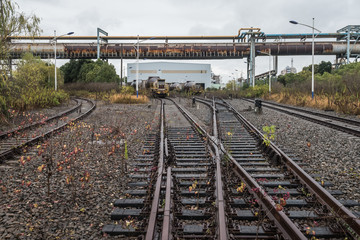 cargo trains stopped on old railroad in abandoned industrial site