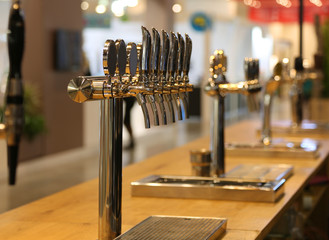beer taps on the counter of an Irish pub