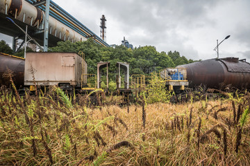 cargo trains stopped on old railroad in abandoned industrial site