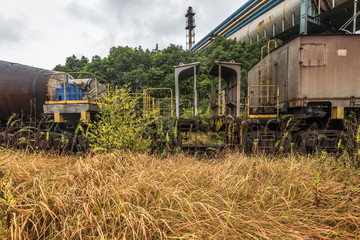 cargo trains stopped on old railroad in abandoned industrial site