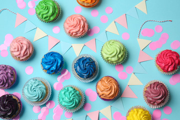 Fototapeta na wymiar Different cupcakes on color background