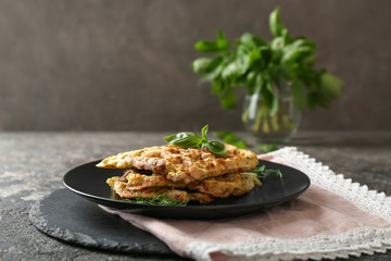 Plate with tasty squash waffles on grey table