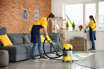 Team of janitors cleaning flat