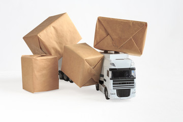 online shopping / e-commerce and delivery: paper boxes on a truck depict customers ordering goods from online retail sites, delivery, freight, on a white background