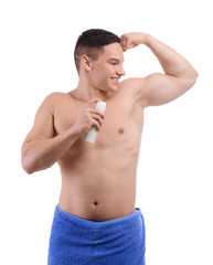 Young man with deodorant on white background