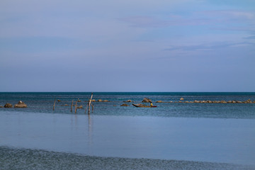 A fisherman on the sea with his boat.
