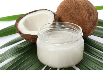 Jar with coconut oil on white background