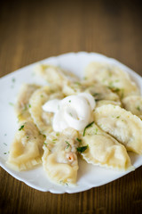 Dumplings boiled with stuffing on a wooden table