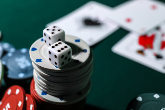 Chips and dices on table in casino, closeup