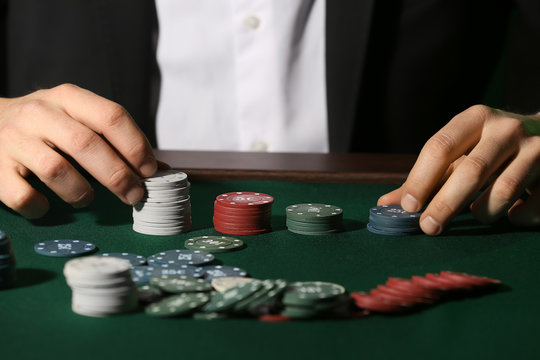 Male player at table in casino, closeup