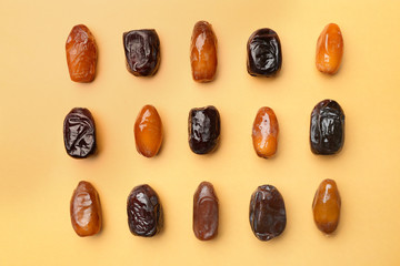 Sweet dried dates on color background