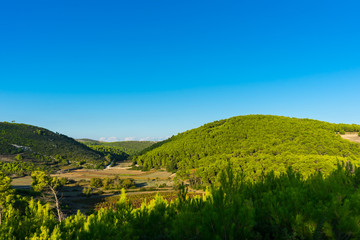 Fototapeta na wymiar Greece, Zakynthos, Green hills and blue sky nature landscape in dawning atmosphere