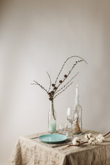 Festive winter table set with glass bottles