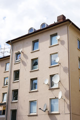 residential building with many satellite dishes