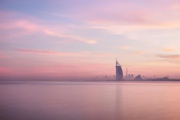 Wall murals Burj Khalifa Stunning view of Dubai skyline from Jumeirah beach to Downtown lighted with warm pastel sunrise colors. Dubai, UAE.