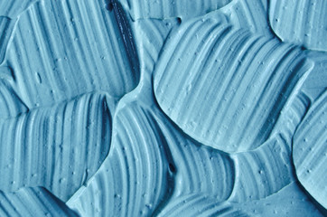 Fototapeta premium Blue cambrian cosmetic clay (facial mask, cream, body scrub) texture close up. Abstract background with brush strokes.