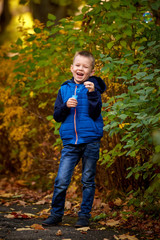 Little boy playing with soap bubbles, outdoor