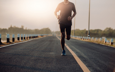 Athlete runner feet running on road