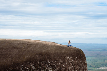 Obraz premium Woman Enjoy the Fresh Air and Embrace the Natureon the three whale rock mountain at Phu Sing , Bueng Kan Province,Thailand
