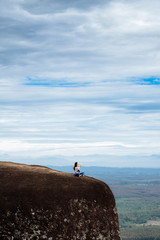 Obraz premium Woman Enjoy the Fresh Air and Embrace the Natureon the three whale rock mountain at Phu Sing , Bueng Kan Province,Thailand