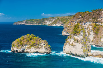 Rocky cliff and blue ocean in Nusa Penida island, Indonesia.