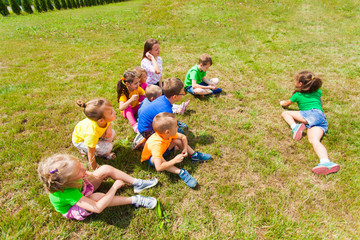Top view of group of children playing on grass