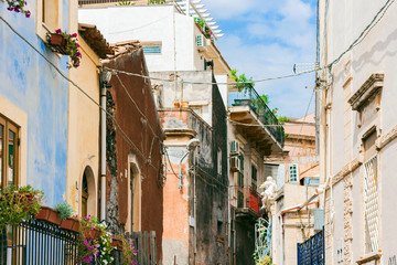 Fototapeta na wymiar Travel to Italy - historical street of Catania, Sicily, facade of ancient buildings