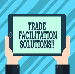 Text sign showing Trade Facilitation Solutions. Conceptual photo harmonisation of international trade procedures Hu analysis Hand Holding Blank Screen Tablet Smartphone Display Unit photo