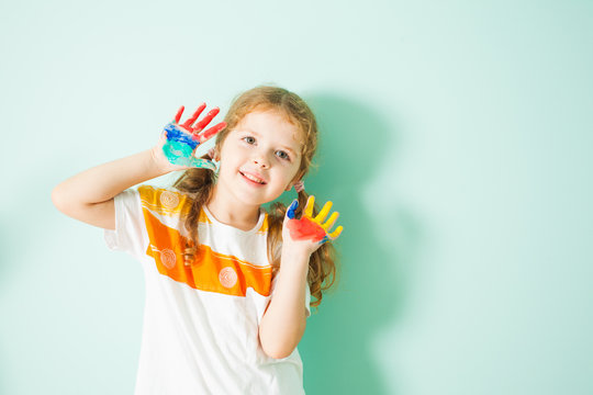 Portrait of happy smiling girl with colored hands