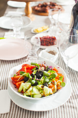 Salad with fresh vegetables, olives and pumpkin sprouts