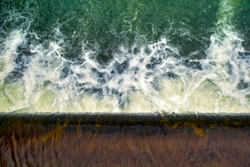 water flowing over the dam