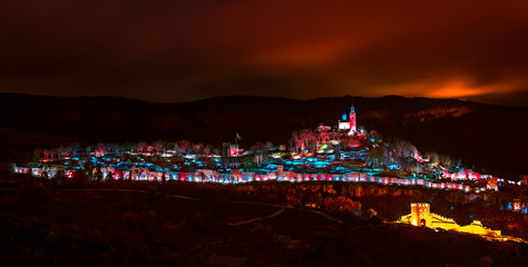 Fototapeta na wymiar Show of lights under the red sky, Tsarevets fortress, Veliko Tarnovo city, Bulgaria