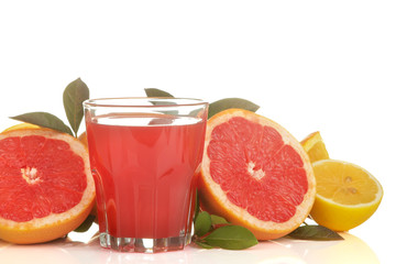 Citrus juices. grapefruit juice in a glass with fresh fruit on a white isolated background