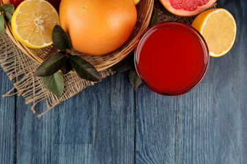 Citrus juices. grapefruit juice with fresh fruit on a blue wooden table. view from above. space for text