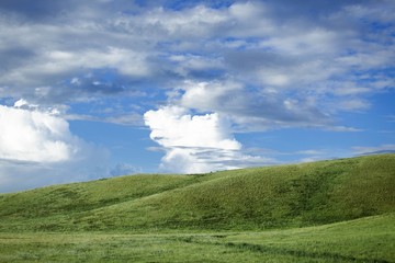  green mountain and blue sky with clouds