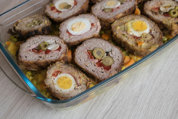 meat roll stuffed with egg, olives, ham and pepper