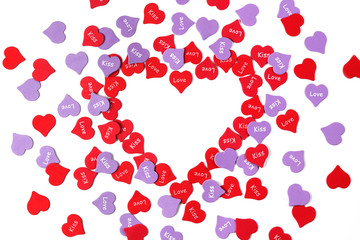 On the table are figures in the shape of a heart. The inscription in English, love and kiss. Concept of holiday or congratulations, top view, flat lay.