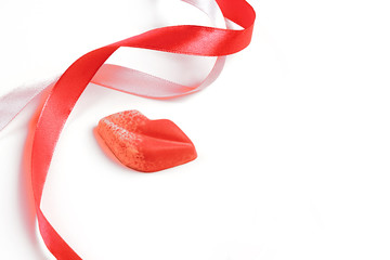 On the table is a figure in the shape of lips, ribbons. Holiday concept or greetings. Selective focus, place for text.