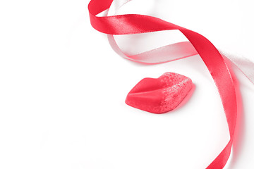 On the table is a figure in the shape of lips, ribbons. Holiday concept or greetings. Selective focus, place for text.