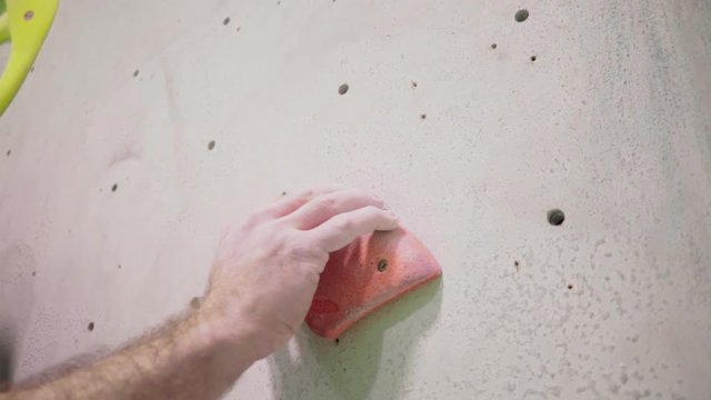 indoor climber climbing bouldering exercise leisure hand grabs hold man slow motion