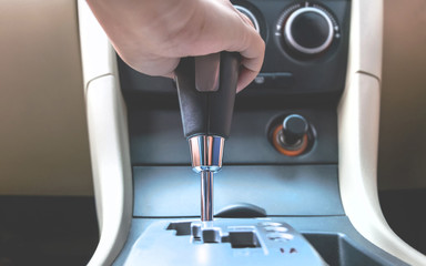 close up hand holding to change the gear inside a car